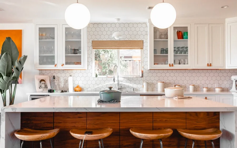 Walnut kitchen island with a white quartz waterfall countertop and glass-front uppers
